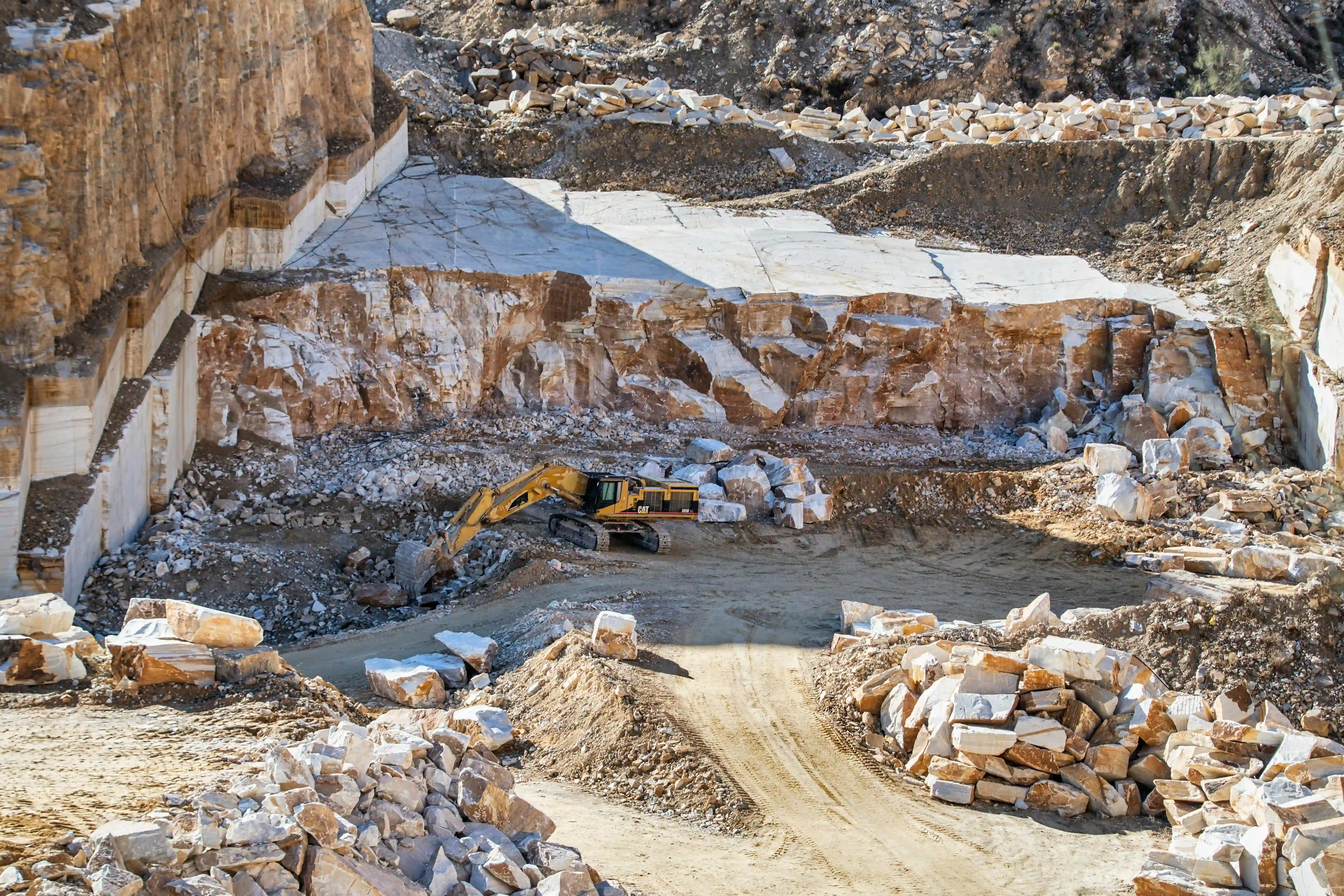 Mining and precious metals operation — open quarry with excavator